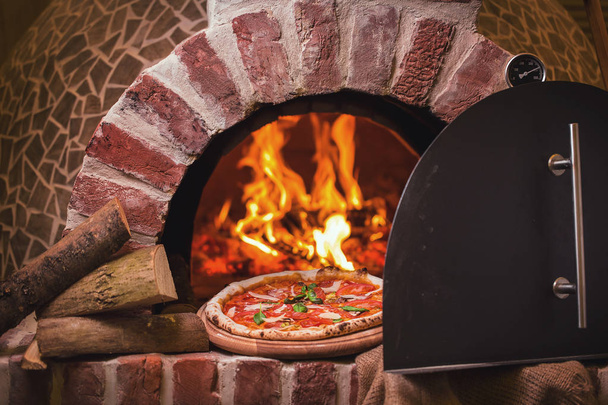 tasty pizza out of oven in restaurant kitchen - Photo, Image