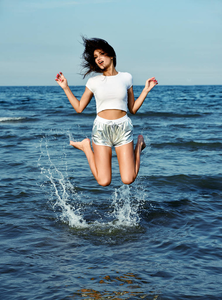 happy beautiful girl  jump in the sea water - 写真・画像