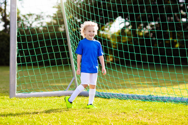 Kids play football. Child at soccer field. - Fotoğraf, Görsel