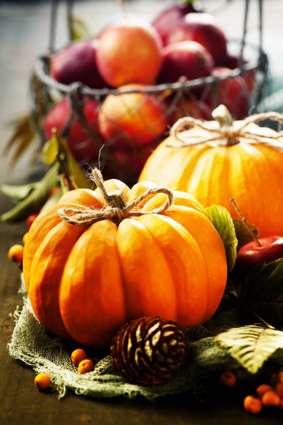 Autumn still life with pumpkins, apples and leaves on old wooden background - Foto, afbeelding
