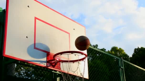 Basketball on the street, training hitting the ball for basketball in the basket. The concept of sports, training, training on the street, self-motivation, discipline, achieving success. Close-up of a - Footage, Video