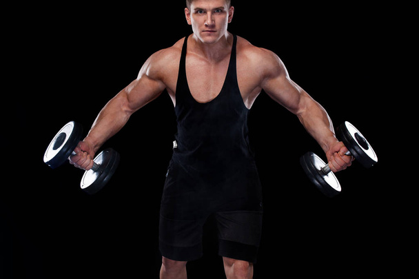 Muscular fitness sports man, atlete with dumbbell in fitness gym. Energy and power. - Foto, imagen