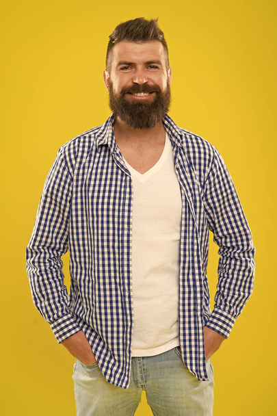 Bearded and happy. Hipster appearance. Beard fashion and barber concept. Man bearded rustic hipster stylish beard yellow background. Barber tips maintain beard. Stylish beard and mustache care - Photo, image