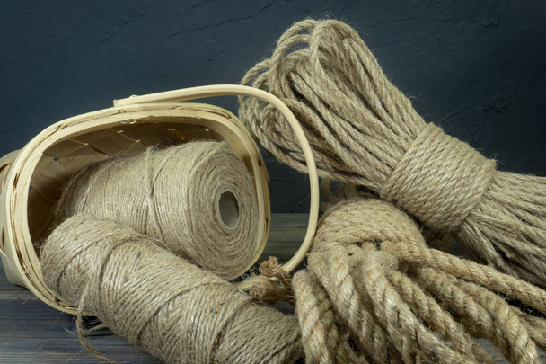 Jute rope and spools of burlap threads or twine - 写真・画像