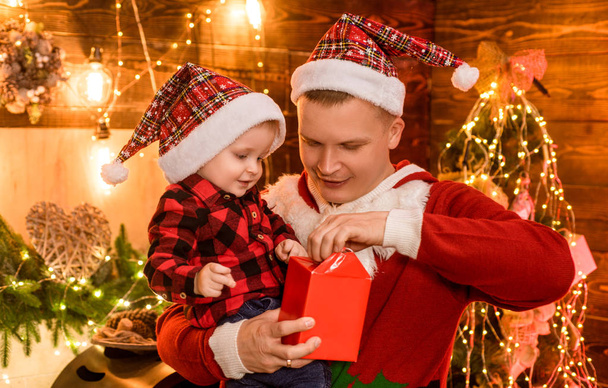 Father and baby son celebrate christmas at home. Winter holidays concept. Magic atmosphere family holidays. Fatherhood joy. Enjoy every moment with his son. Spend holidays together. Family love - Foto, Imagen