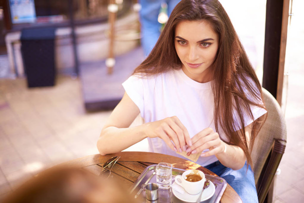Portrait shot of young woman drinking her espresso in outdoor ca - Foto, imagen