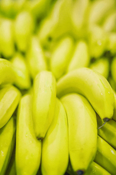 Fresh clear banana yellow green unripe background texture vertical - Photo, Image