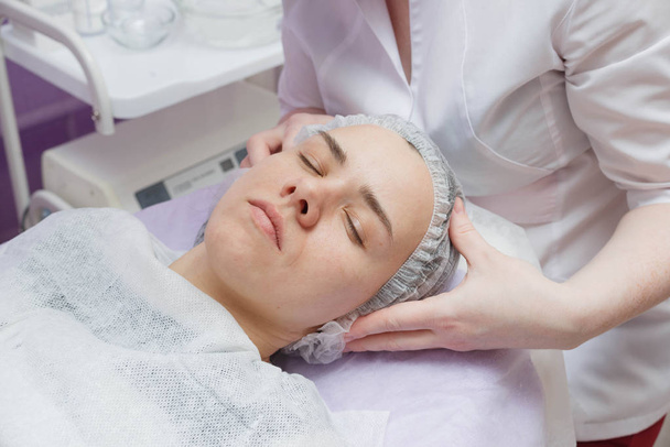 woman getting ultrasound skin cleaning at beauty salon - Photo, Image