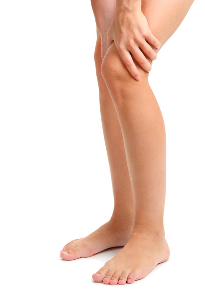 woman holding sore leg, isolated on white - Foto, Imagem