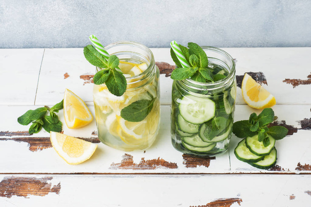 Detox water for healthy lifestyle. Fresh water in jar with lemon, cucumber and mint on wooden table. - Φωτογραφία, εικόνα