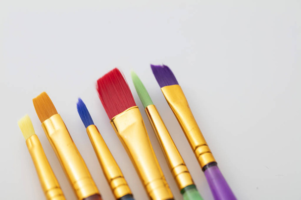 Colourful creative paintbrush art supply background - Foto, Imagem