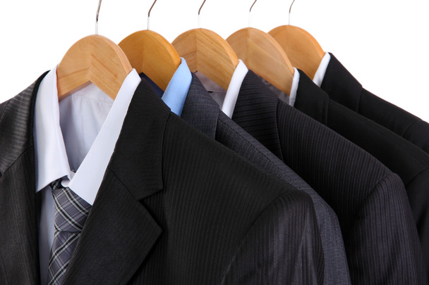 Suits with shirts on hangers on white background - Fotoğraf, Görsel