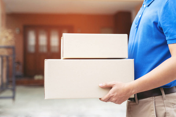 parcel delivery man of a package through a service send to home. consign hand Submission customer accepting a delivery of boxes from delivery man. - 写真・画像