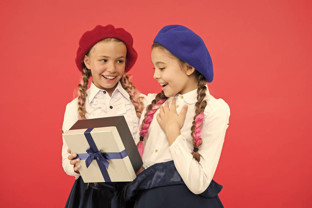 What a wonderful surprise. Happy children with small gift box wrapped with ribbon bow. Little girl giving present to friend. Small kids enjoying holiday celebration. Birthday surprise. Happy birthday - Fotografie, Obrázek