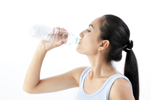 Sporty woman drinking water, isolated against white background - Valokuva, kuva