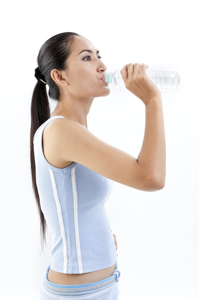 Sporty woman drinking water, isolated against white background - Zdjęcie, obraz