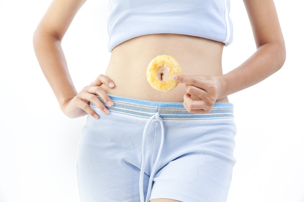 Diet woman holding donut - Φωτογραφία, εικόνα