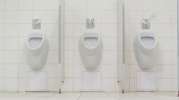 mannen met behulp van urinoirs in supermarkt toilet - Video