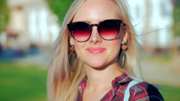 Portrait of European Cute Blonde in with Sunglass Young Happy Woman or Cheerful Girl Looking in The Camera, Blowing Wind Hair the Wind , Slow Motion. - Felvétel, videó
