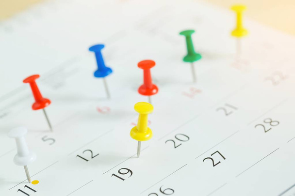 отметьте день мероприятия значком. Thumbtack in calendar concept for busy timeline organize schedule, appointment meeting reminder. планирование деловой встречи или планирование путешествия. мягкий фокус
 - Фото, изображение