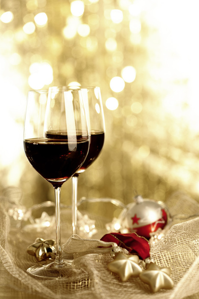 δύο ποτήρια κόκκινο κρασί και χριστουγεννιάτικα στολίδια - Φωτογραφία, εικόνα