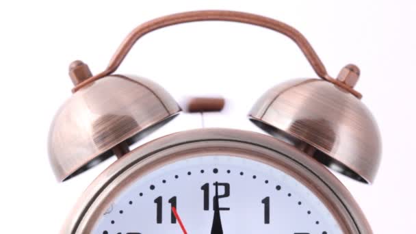 Close-up shot of ringing alarm bell clock on white - Кадры, видео