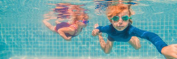 Kids having fun playing underwater in swimming pool on summer vacation BANNER, LONG FORMAT - Photo, image