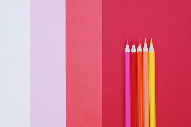 Abstract geometric paper background with color pencils. Pink and coral trendy colors. School and education concept. - Photo, Image
