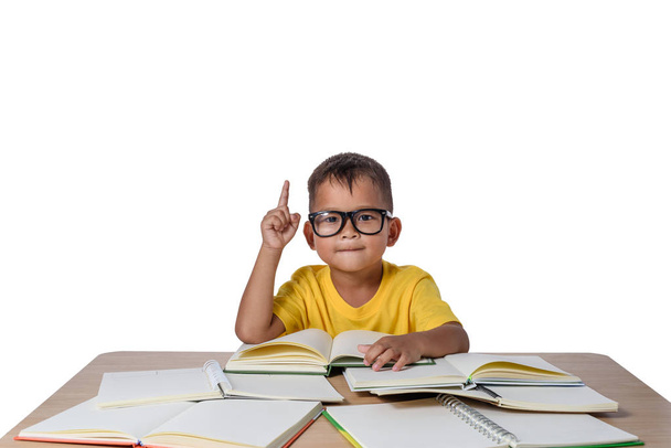 little girl with glasses thought and many book on the table. bac - Photo, image