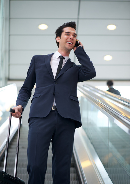 Attractive young businessman talking on mobile phone - Fotoğraf, Görsel