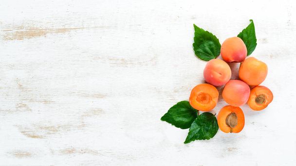 Apricots on a white wooden background. Rustic style. Top view. Free space for your text. - Valokuva, kuva