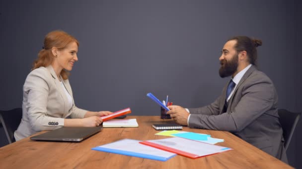 Two Business Colleagues Exchanging Their Folders - Video
