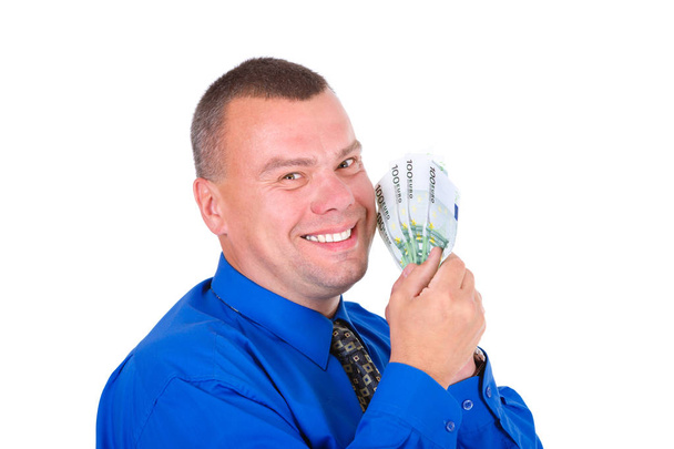 Closeup portrait of happy, successful, lucky business man in shirt and tie holding money euros banknotes in hands. Looking to camera. isolated white background. Positive emotion. Reward savings - Photo, Image