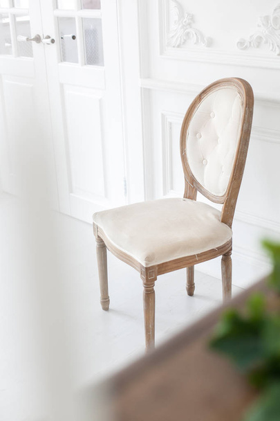 Vintage chair with textile upholstery in a luxurious interior. Soft focus. - 写真・画像