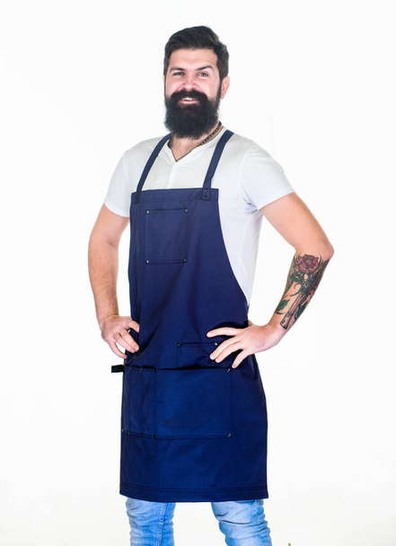 Casual and stylish. Happy cook wearing cooking apron with pockets. Cook in apron keeping hands on hips. Bearded cook happy smiling in kitchen apron. Confident grill cook with long beard and mustache - Фото, зображення