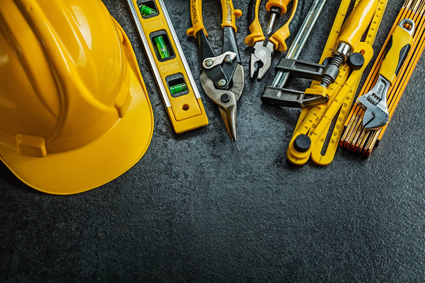 set of yellow construction tools on black background - Фото, изображение