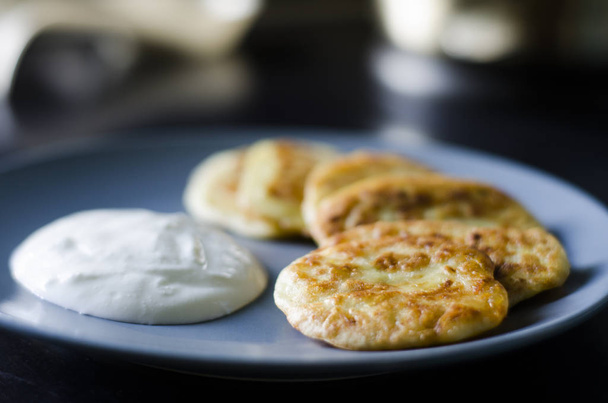 Pancakes with zucchini vegetable and sour cream. - Фото, зображення