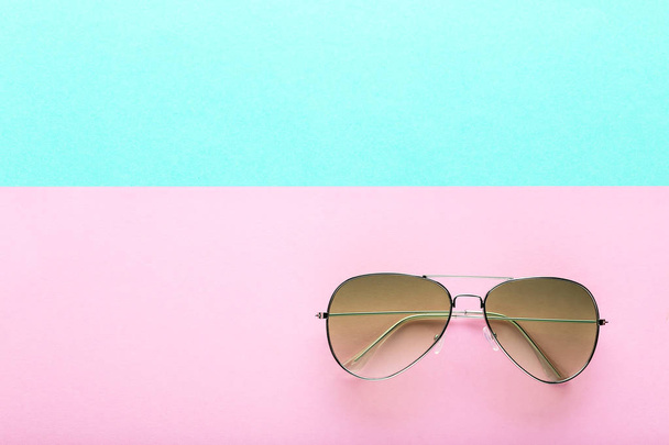 Modern sunglasses on colorful background - 写真・画像