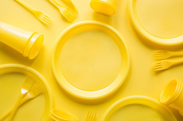 Singe use picnic utensils for recycling on yellow. Environment eco friendly discarded plastic garbage collection for recycle concept.Top view. Flat lay. - Fotoğraf, Görsel