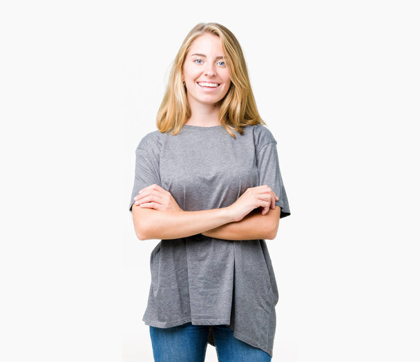Beautiful young woman wearing oversize casual t-shirt over isolated background happy face smiling with crossed arms looking at the camera. Positive person. - Photo, Image