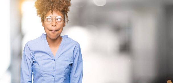 Beautiful young african american business woman over isolated background making fish face with lips, crazy and comical gesture. Funny expression. - Valokuva, kuva