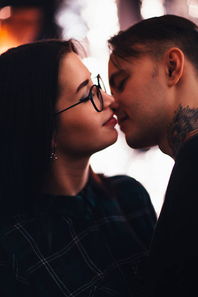 guy and the girl kiss closeup on a light background. - 写真・画像