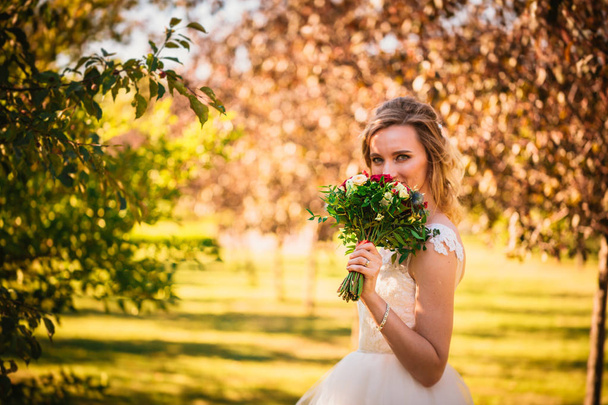 happy young bride on autumn forest background - Foto, Imagen