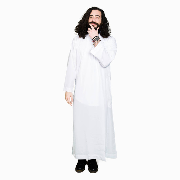 Homem vestindo traje de Jesus Cristo olhando confiante para a câmera com sorriso com os braços cruzados e mão levantada no queixo. Pensar positivo
. - Foto, Imagem
