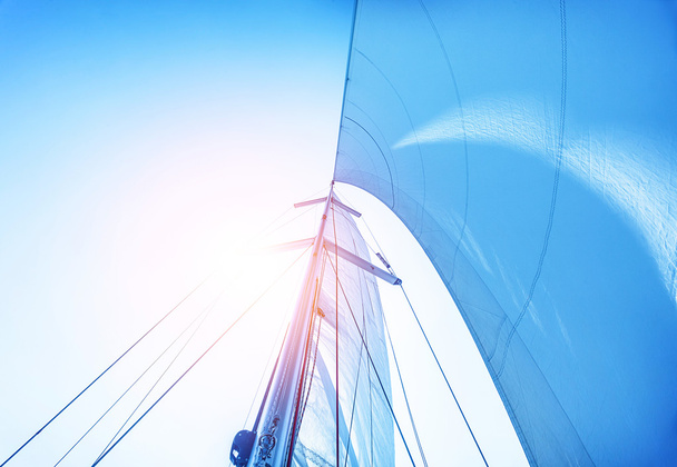Sail on blue sky background - Фото, изображение