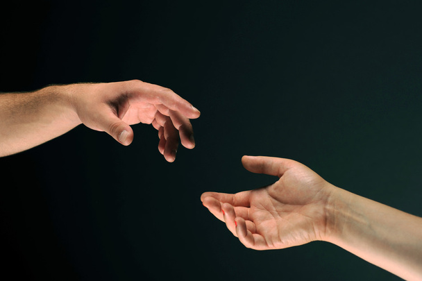 Two hands reaching to each other - 写真・画像