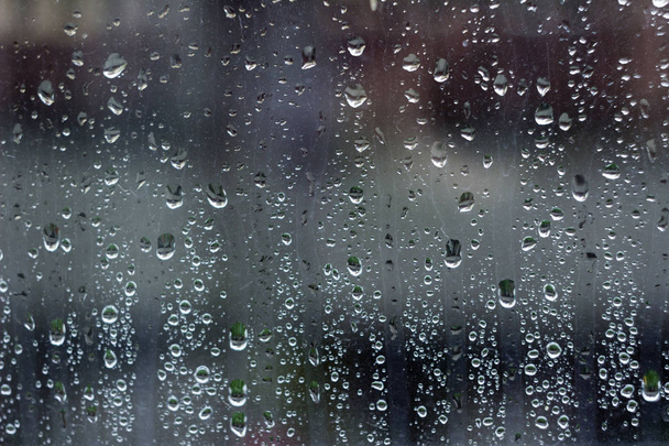 Rain droplets on the window, background. Wet glass. Autumn concept - Photo, Image
