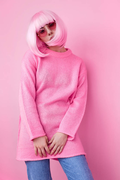 Trendy female in pink wig looking at camera - 写真・画像