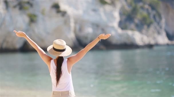 junge schöne Frau am weißen tropischen Sandstrand. Kaukasische Mädchen mit Hut im Hintergrund das Meer - Filmmaterial, Video