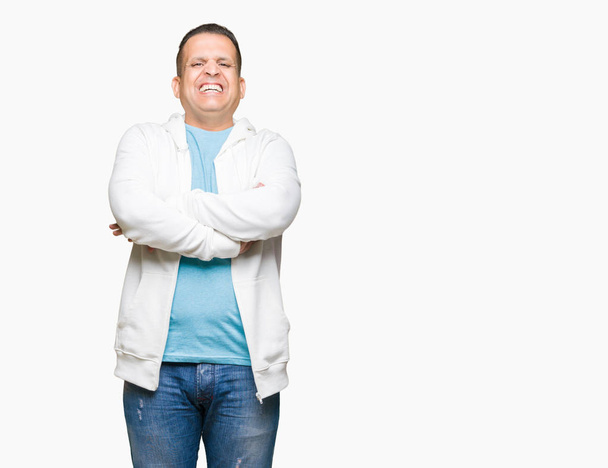 Middle age arab man wearing sweatshirt over isolated background happy face smiling with crossed arms looking at the camera. Positive person. - Foto, Bild